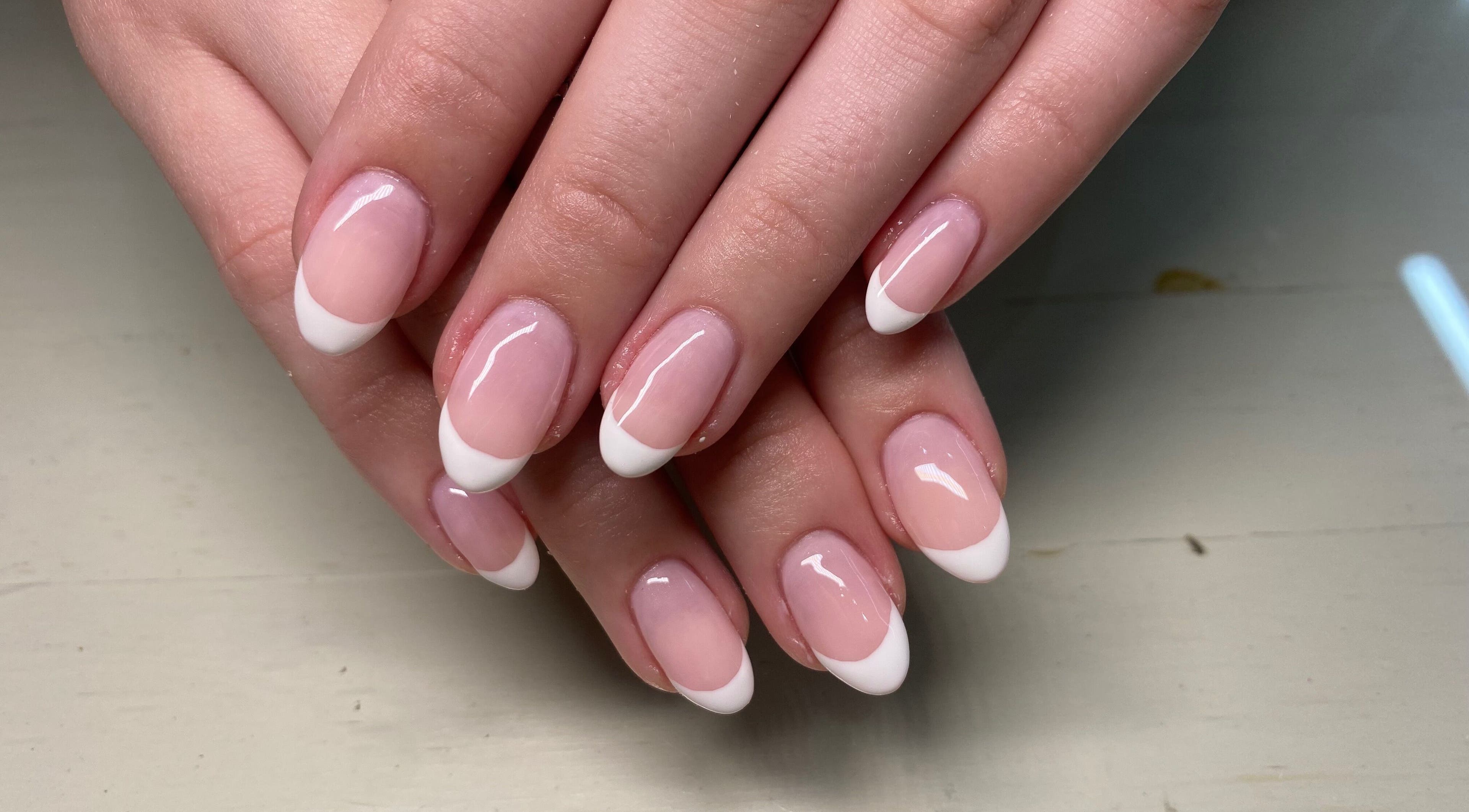 Elegant French manicure nails at Naked Nails, Pretoria, Gauteng, ZA showcasing glossy white tips.
