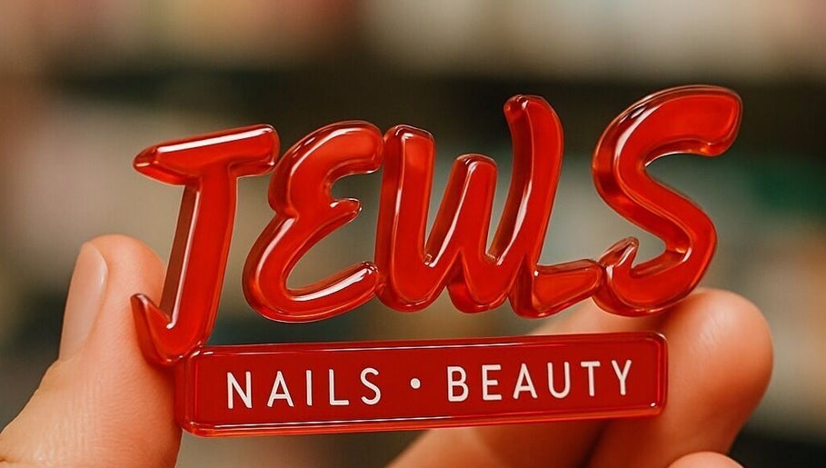 Close-up of JEWLS Nails & Beauty logo charm held by hand in George, Western Cape, ZA.