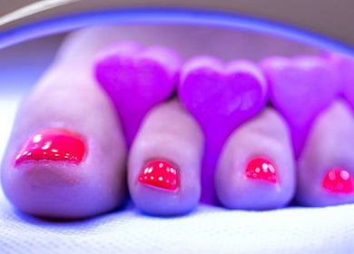 Brightly polished toes with heart-shaped separators at JEWLS Nails & Beauty, George, Western Cape, ZA.