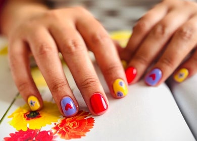 Colorful nail art at JEWLS Nails & Beauty in George, Western Cape, ZA, featuring vibrant floral designs.