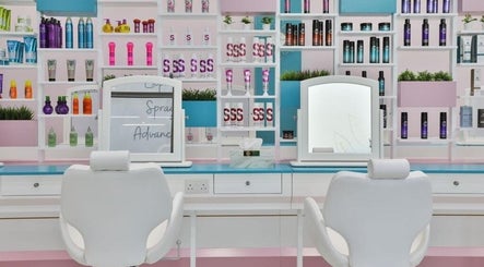 Modern hair salon interior at Refresh Hair & Beauty Bar, Dubai, Dubai, AE, with colorful products and mirrors.