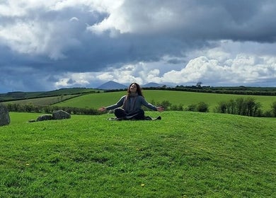 Giovanna Baistrocchi meditating outdoors in Craigavon, Northern Ireland, GB, serene and spacious landscape.