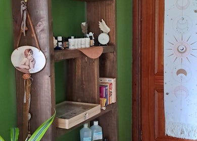 Cozy therapy room of Giovanna Baistrocchi in Craigavon, Northern Ireland, featuring a rustic shelf and wall art.