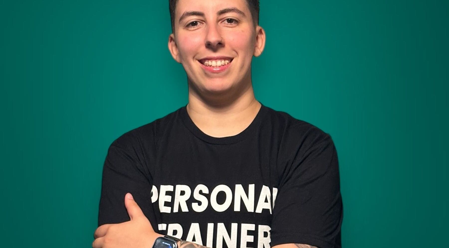 Personal trainer at DSR Studios in London, England, GB, smiling against a teal background.