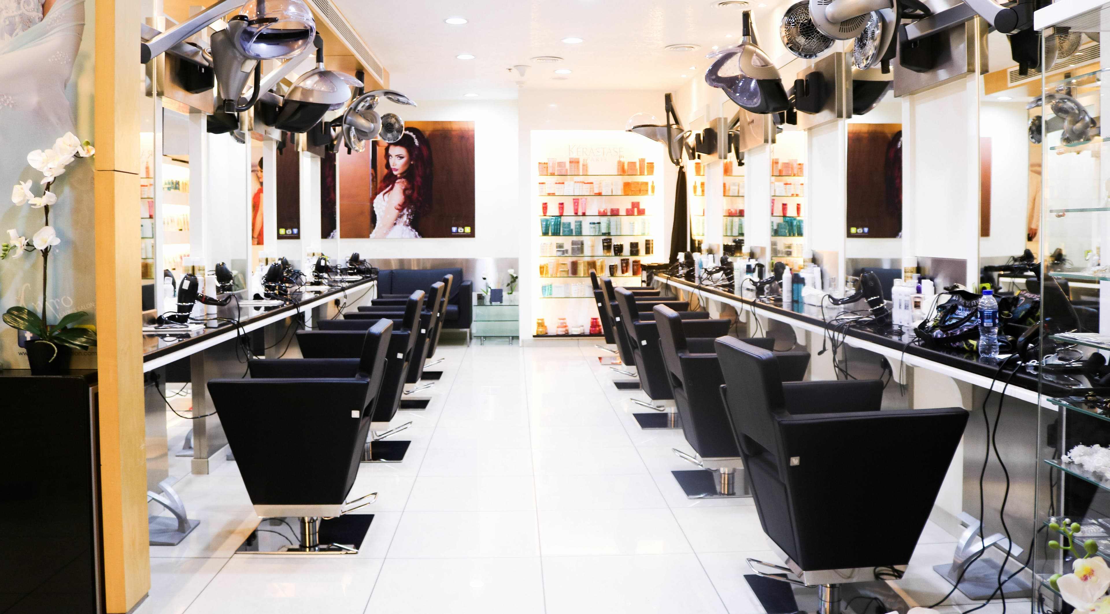 Chic salon interior at Amro - JW Marriott Marquis Hotel - Business Bay, Dubai, Dubai, AE with black chairs and products.
