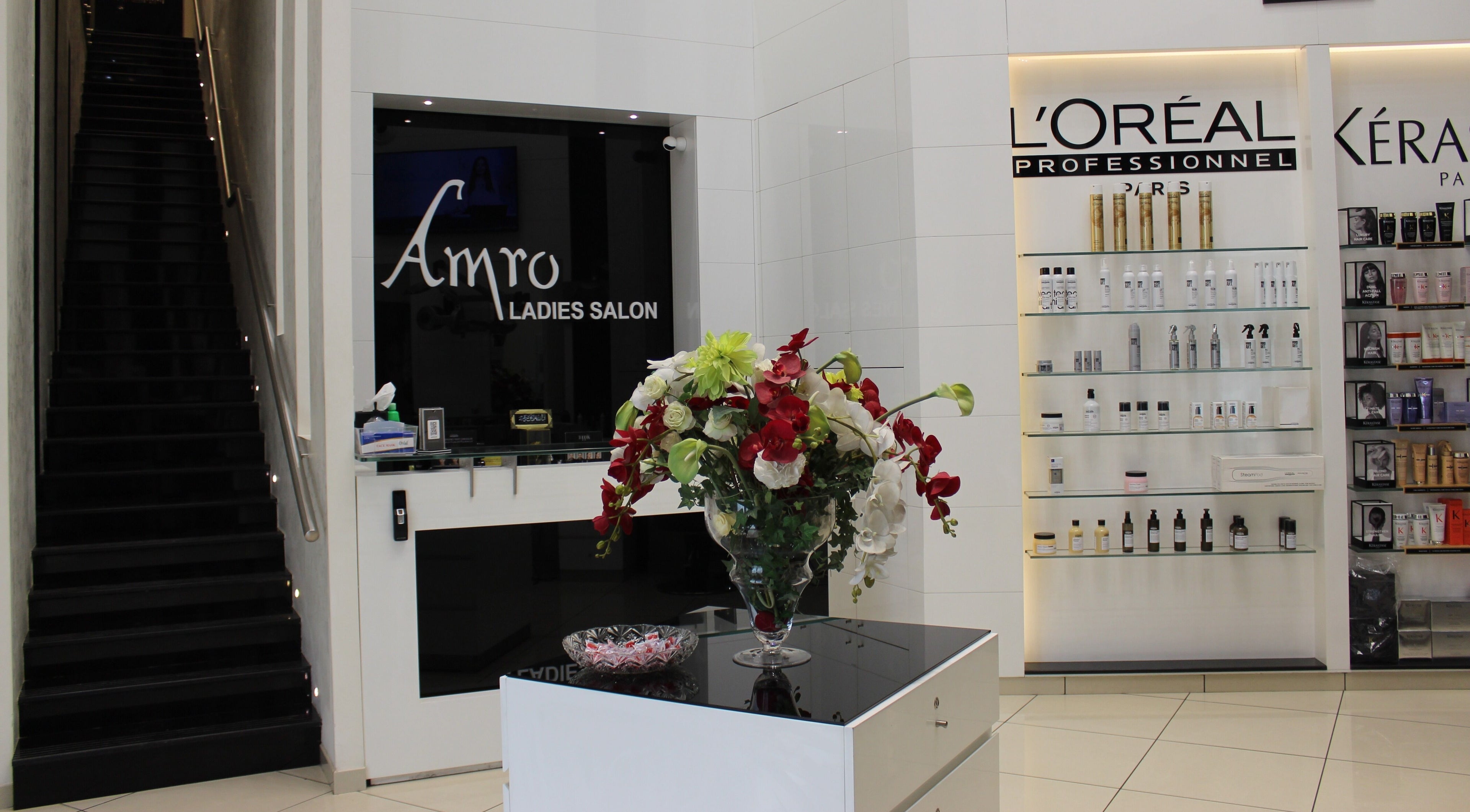 Interior of Amro - Damac in Dubai, Dubai, AE showcasing stairs, flowers, and products on display.