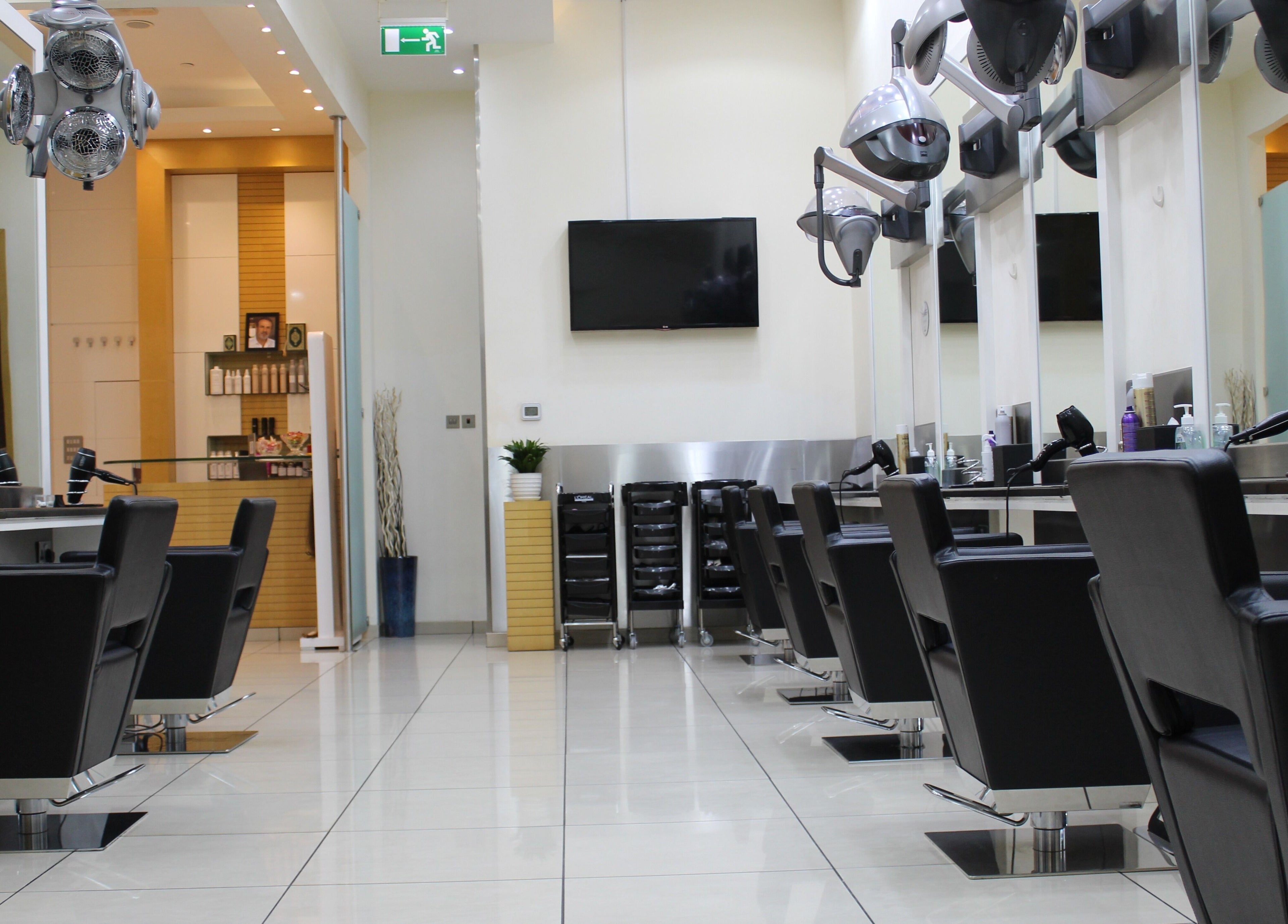 Sleek salon interior at Amro - The Collection Mall - Abu Dhabi, featuring modern black chairs. Abu Dhabi, Abu Dhabi, AE.
