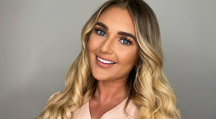 Smiling woman with wavy blonde hair at Jessica Marie Essex, Loughton, England, GB.