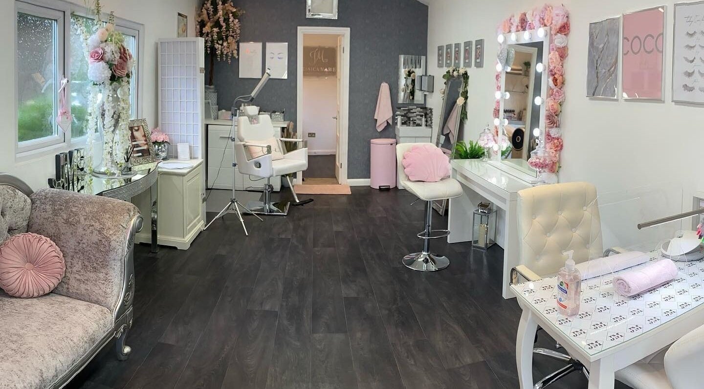 Elegant beauty salon interior at Jessica Marie Essex in Loughton, England, GB with plush seating and floral decor.