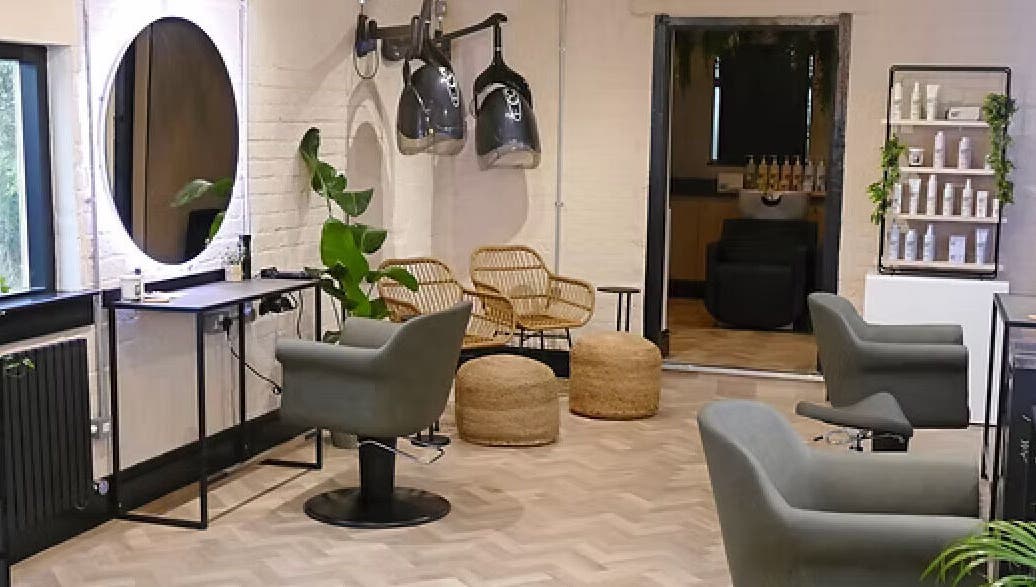 Modern salon interior at The Curl Girl, Sugnall, England, GB with stylish chairs and equipment.