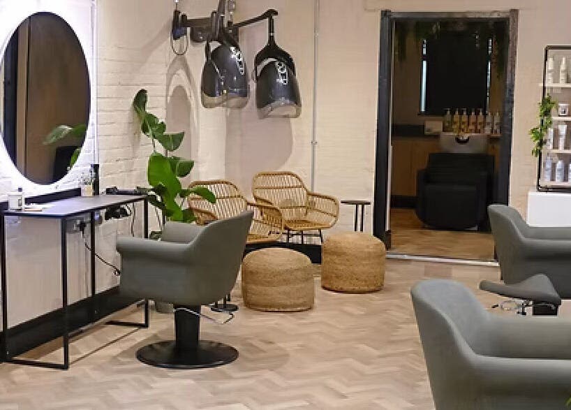 Modern salon interior at The Curl Girl, Sugnall, England, GB with stylish chairs and equipment.