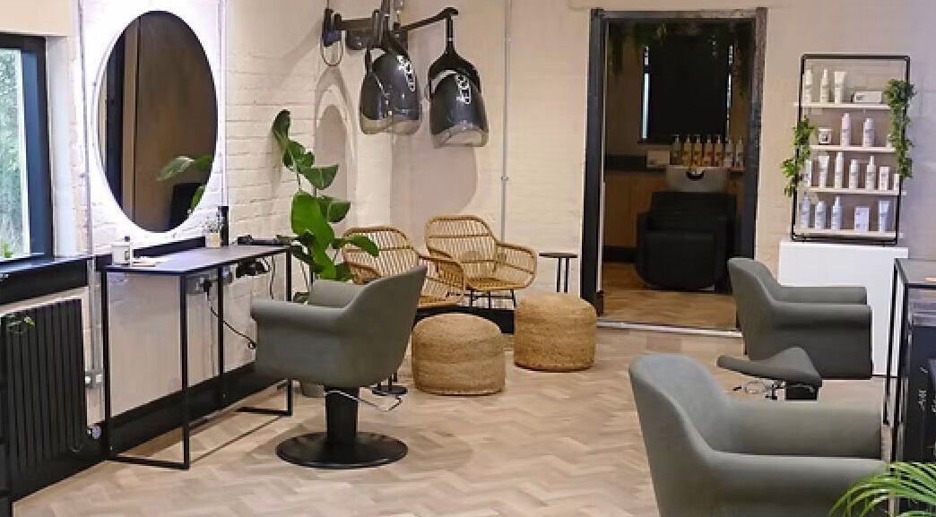 Modern salon interior at The Curl Girl, Sugnall, England, GB with stylish chairs and equipment.