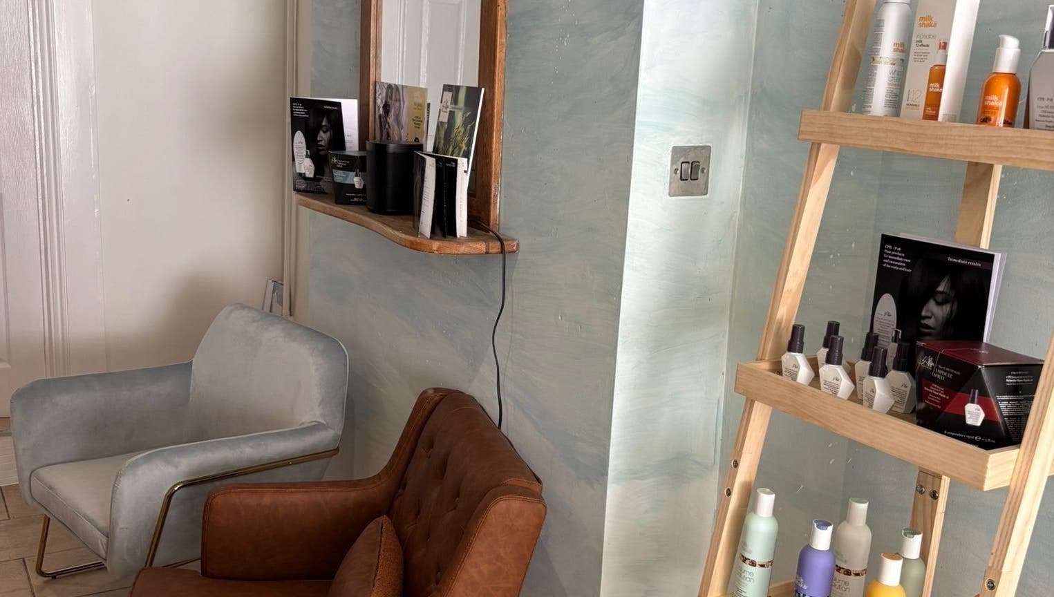 Cozy seating and hair products at The Curl Girl Devon in Braunton, England, GB.