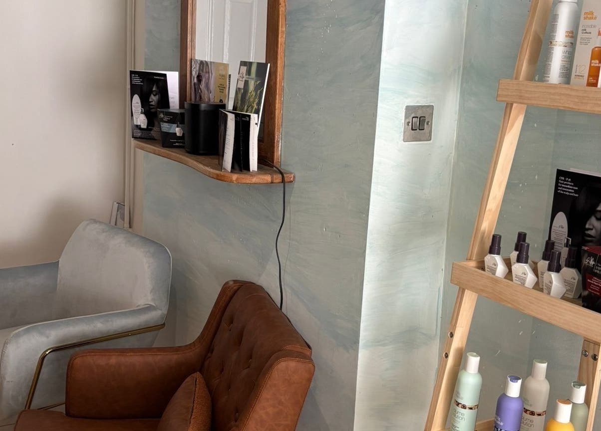 Cozy seating and hair products at The Curl Girl Devon in Braunton, England, GB.