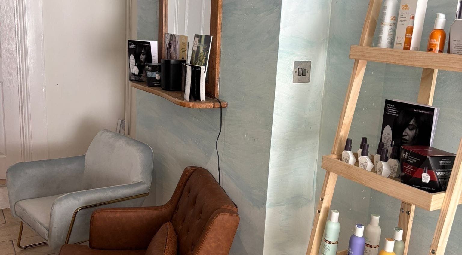 Cozy seating and hair products at The Curl Girl Devon in Braunton, England, GB.