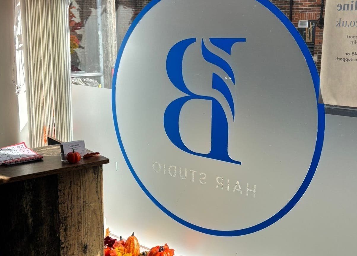 The Curl Girl Devon's frosted glass with stylish logo at Braunton, England, GB.