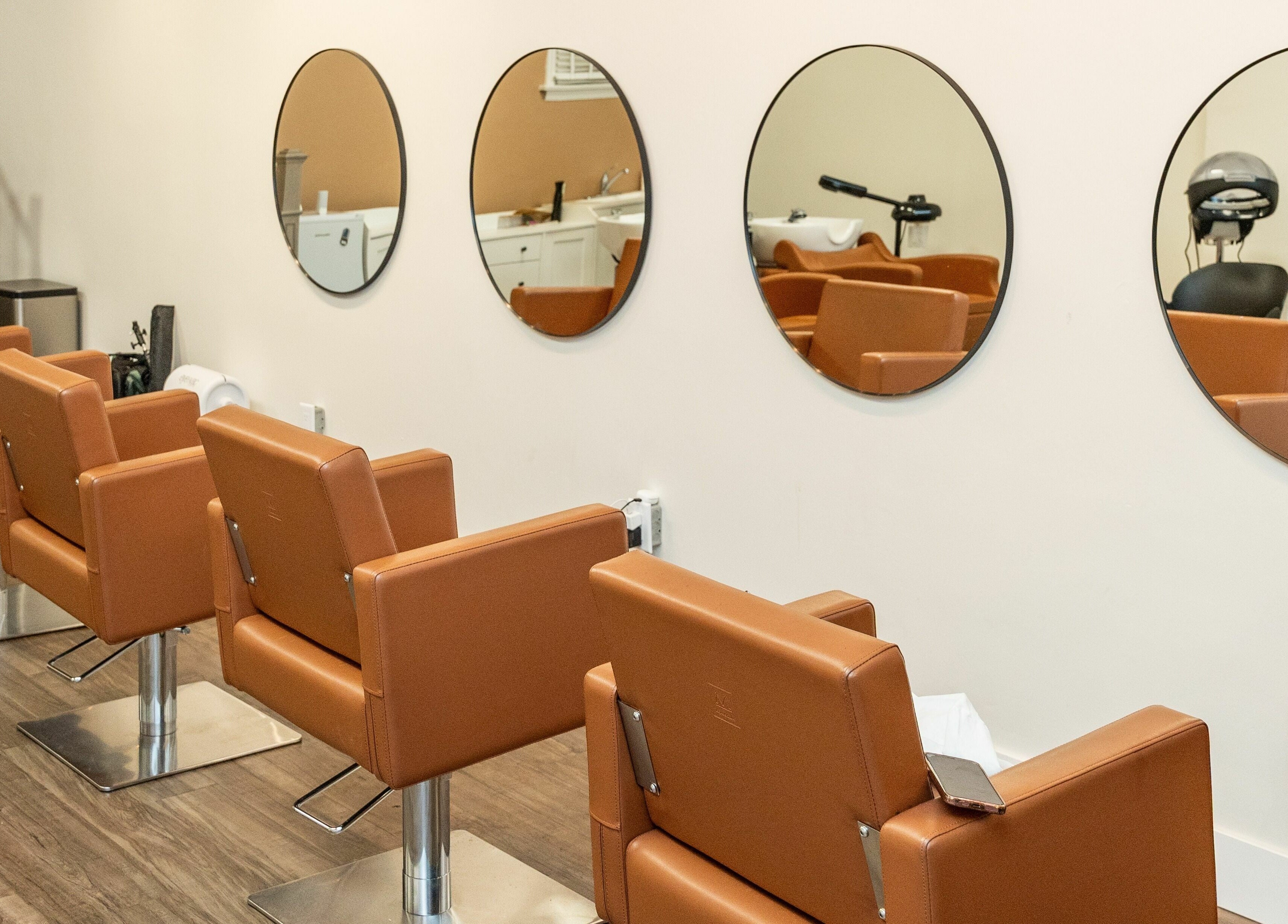 Modern salon chairs and mirrors at Locs by Jiji, Toronto, Ontario, CA.