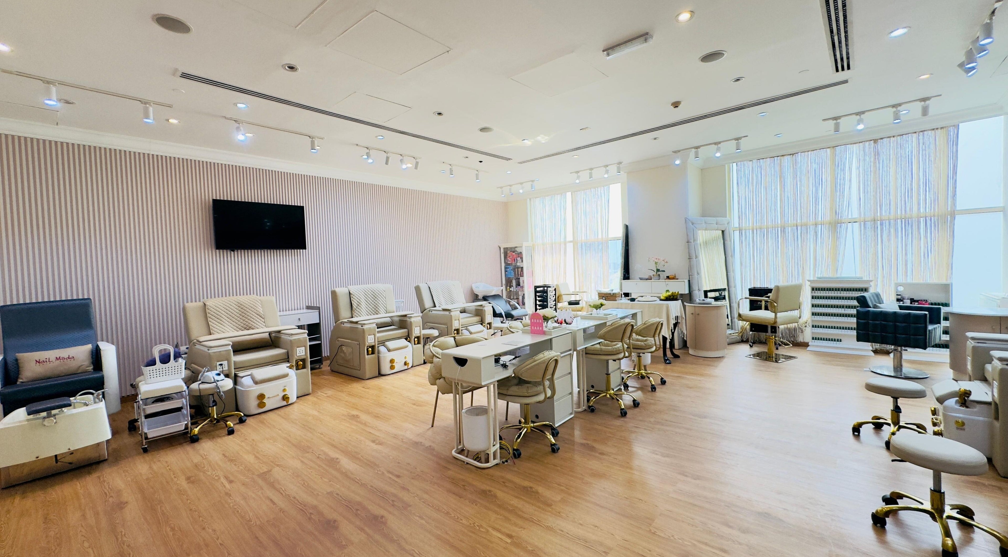 Nail Moda Ladies Salon in Dubai, AE offers elegant pedicure and manicure stations in a spacious setting.