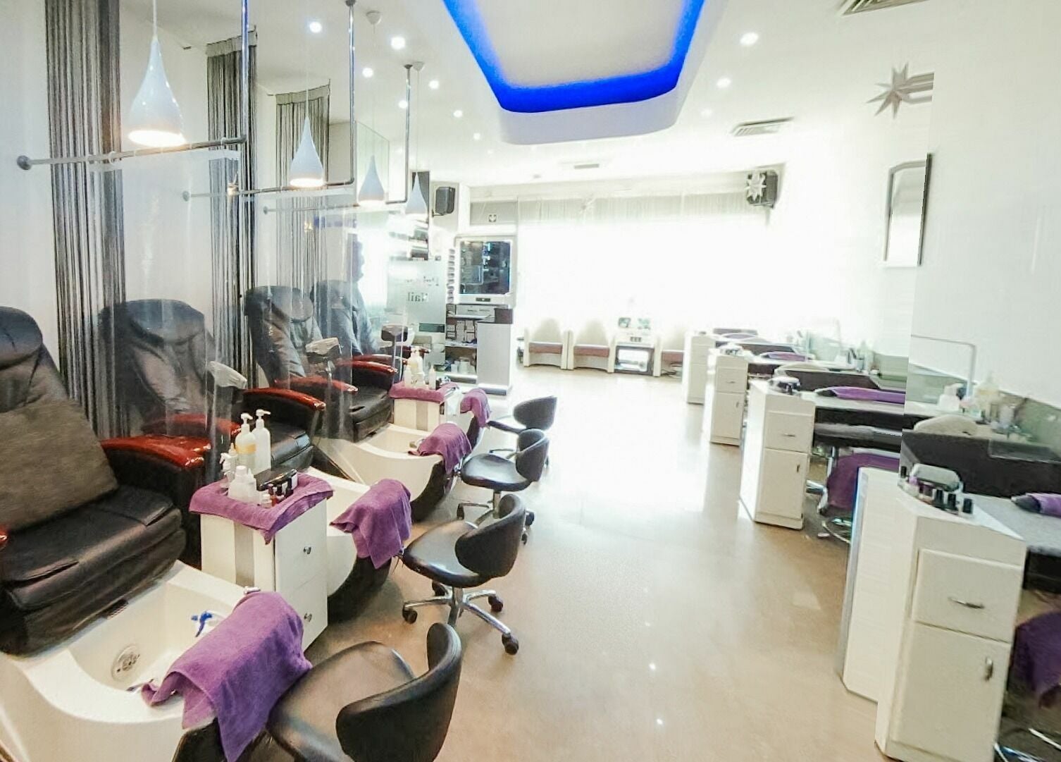 Chic interior of Princess Nails Wimbledon, London, England, GB with plush pedicure chairs.