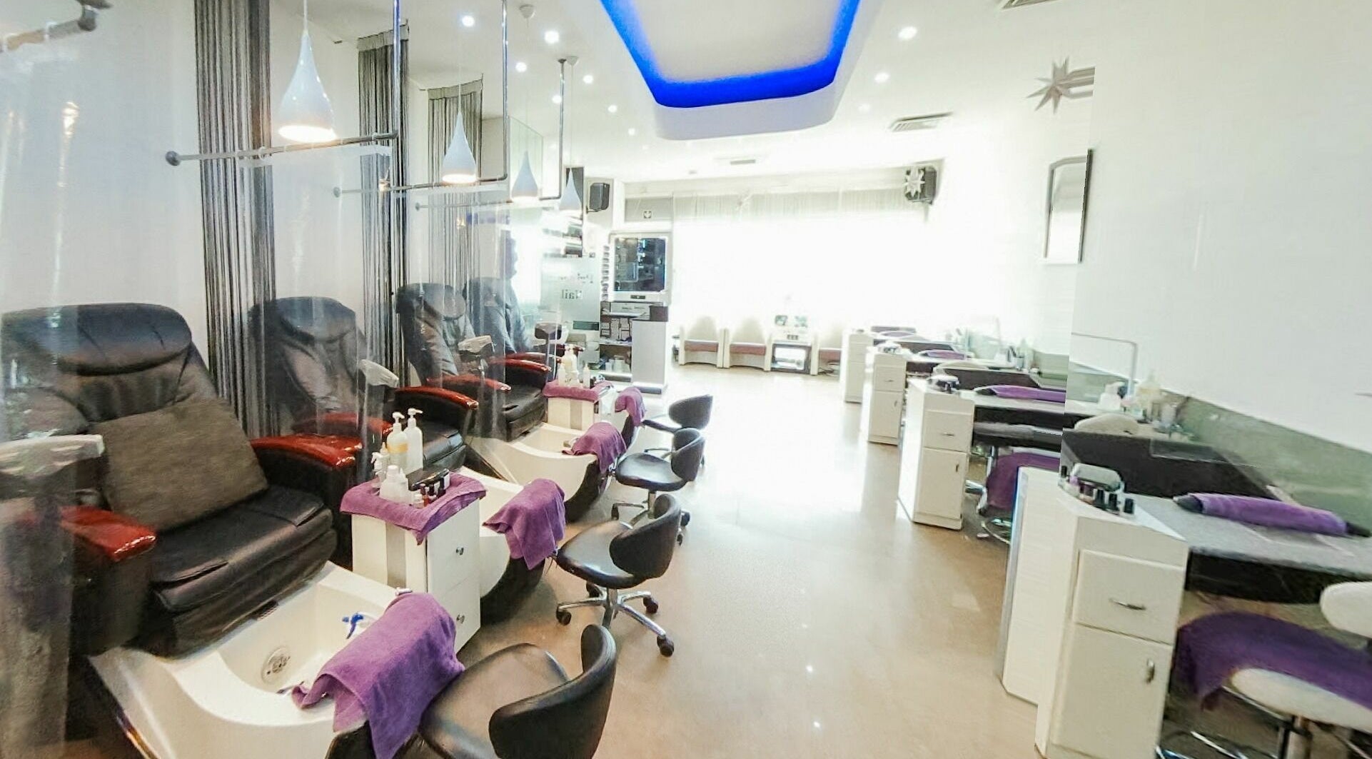 Chic interior of Princess Nails Wimbledon, London, England, GB with plush pedicure chairs.