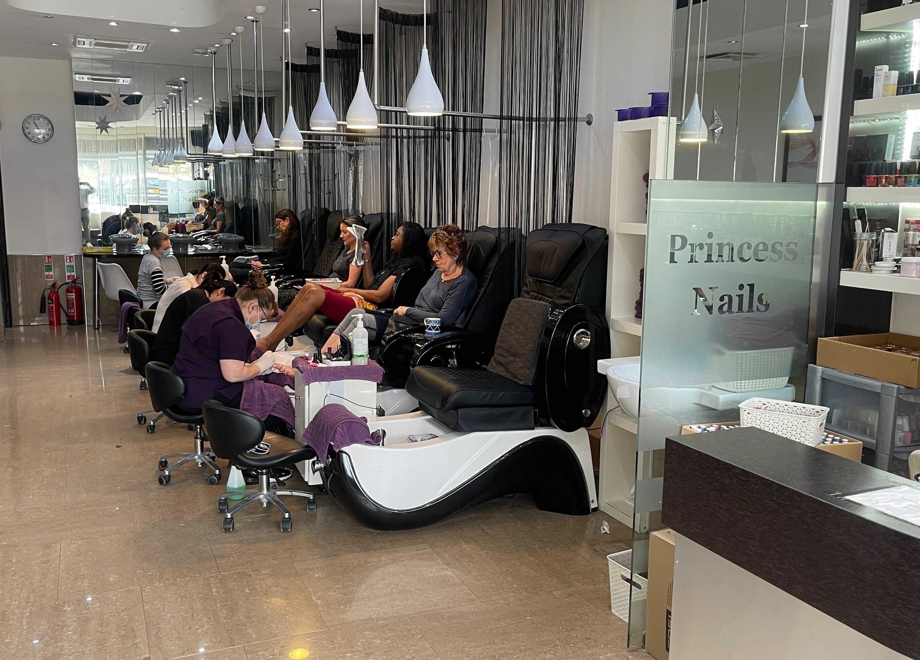 Interior of Princess Nails Wimbledon in London, England, GB featuring stylish nail care stations and clients.