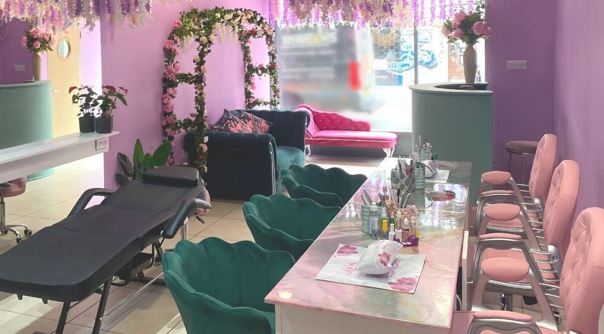 Elegant interior of Society Beauty in Manchester, England, GB, with floral decor and plush seating.