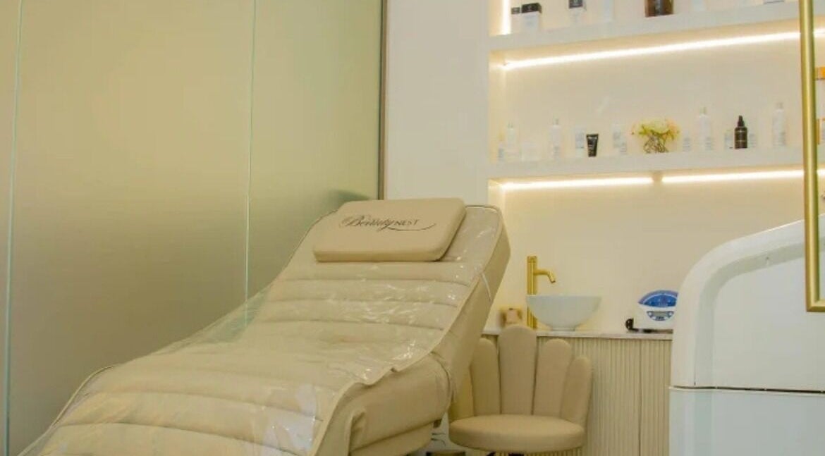 Cozy spa lounge with beige chair at The Beauty Nest, London, England, GB, offering relaxing treatments.