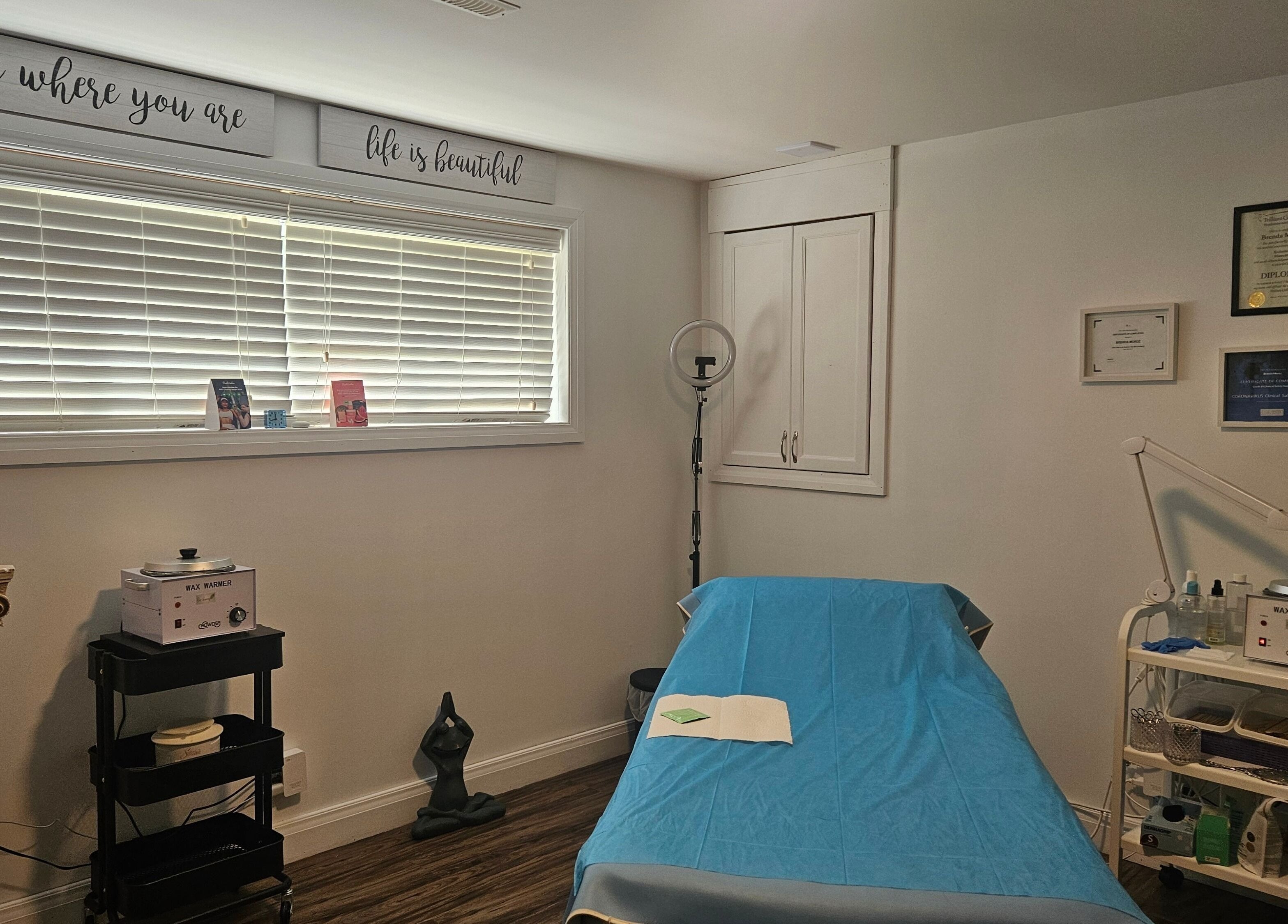 Cozy treatment room at Pure Waxing in Quinte West, Ontario, CA. Featuring a waxing bed, decor, and professional equipment.