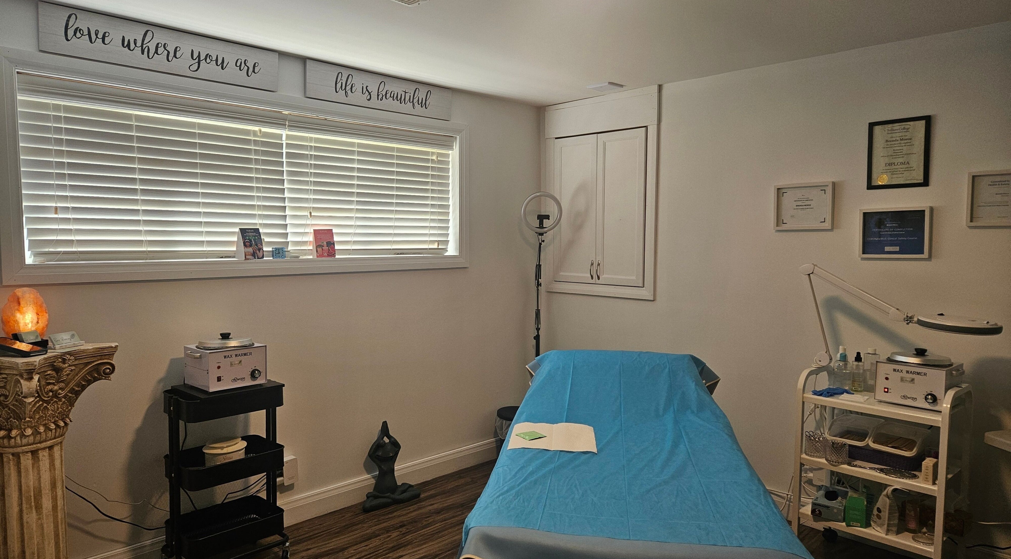 Cozy treatment room at Pure Waxing in Quinte West, Ontario, CA. Featuring a waxing bed, decor, and professional equipment.