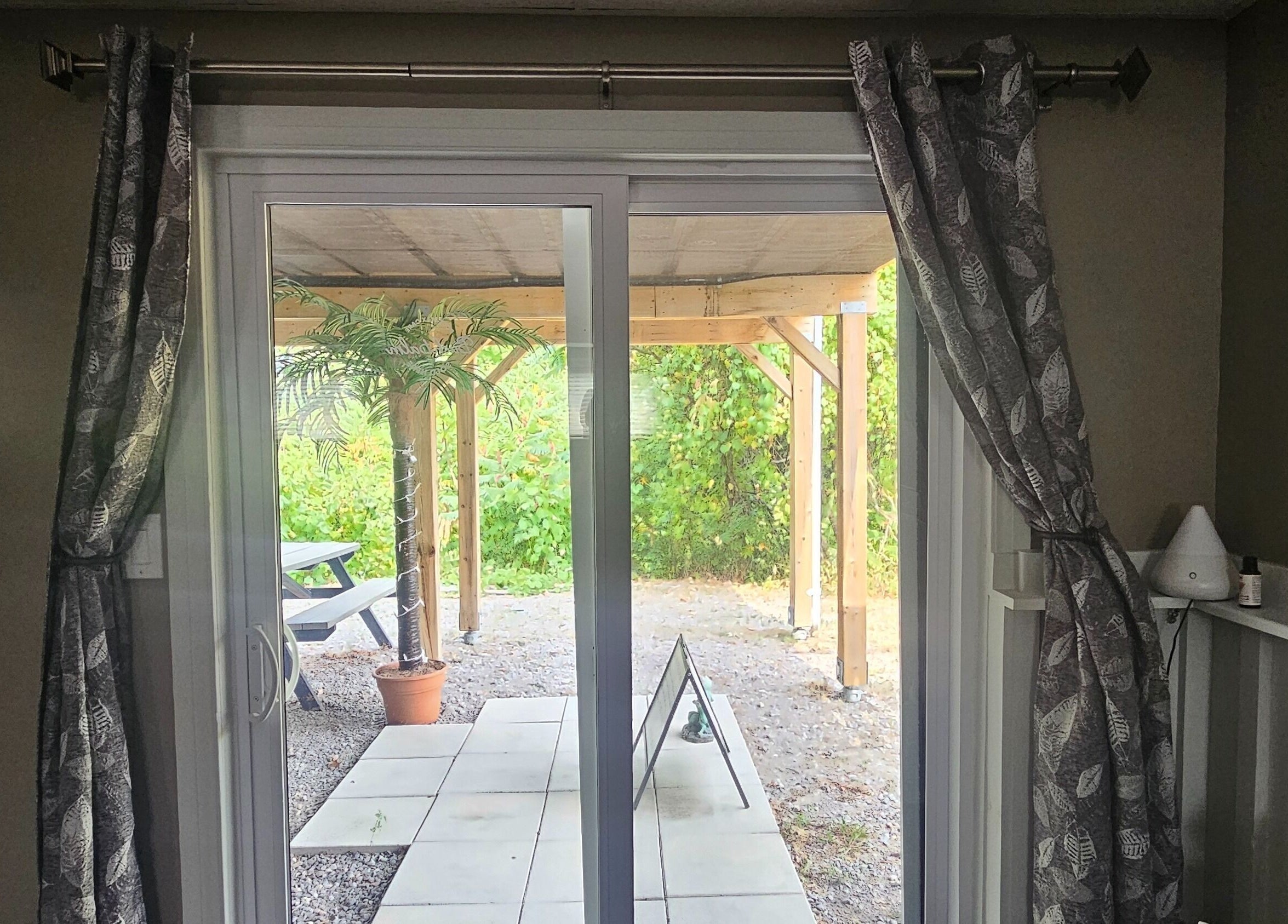 View of outdoor patio with greenery at Pure Waxing, Quinte West, Ontario, CA.