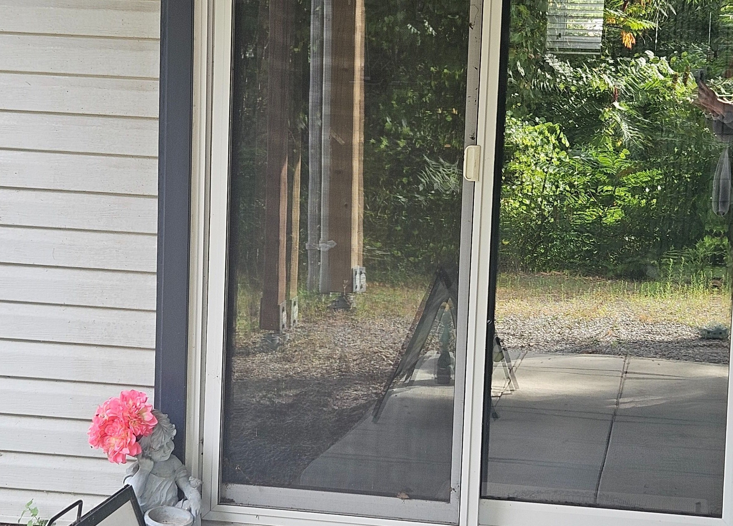 Entrance with glass doors at Pure Waxing, Quinte West, Ontario, CA, surrounded by lush greenery and decor.
