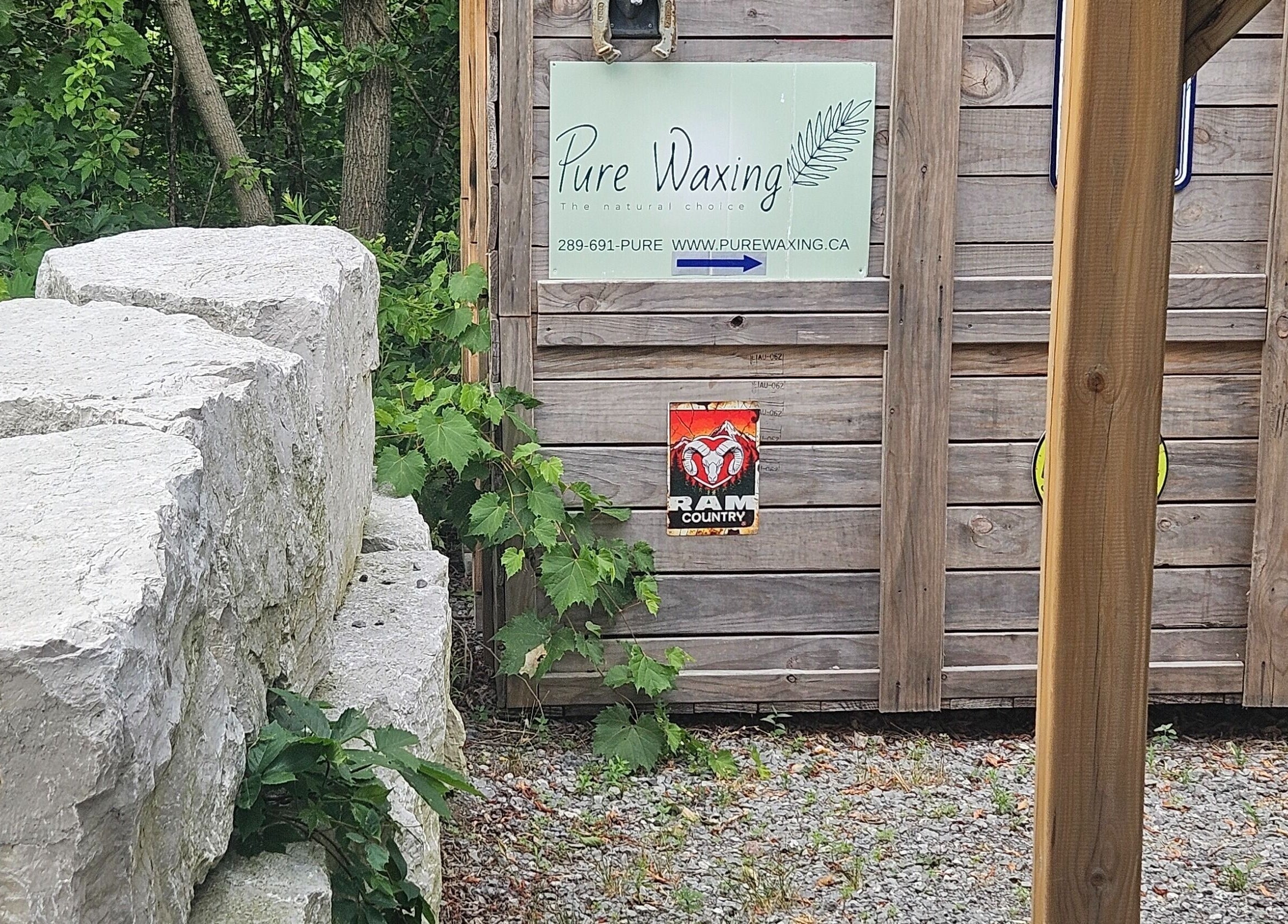 Entrance of Pure Waxing in Quinte West, Ontario, CA, featuring rustic wood and stone decor.