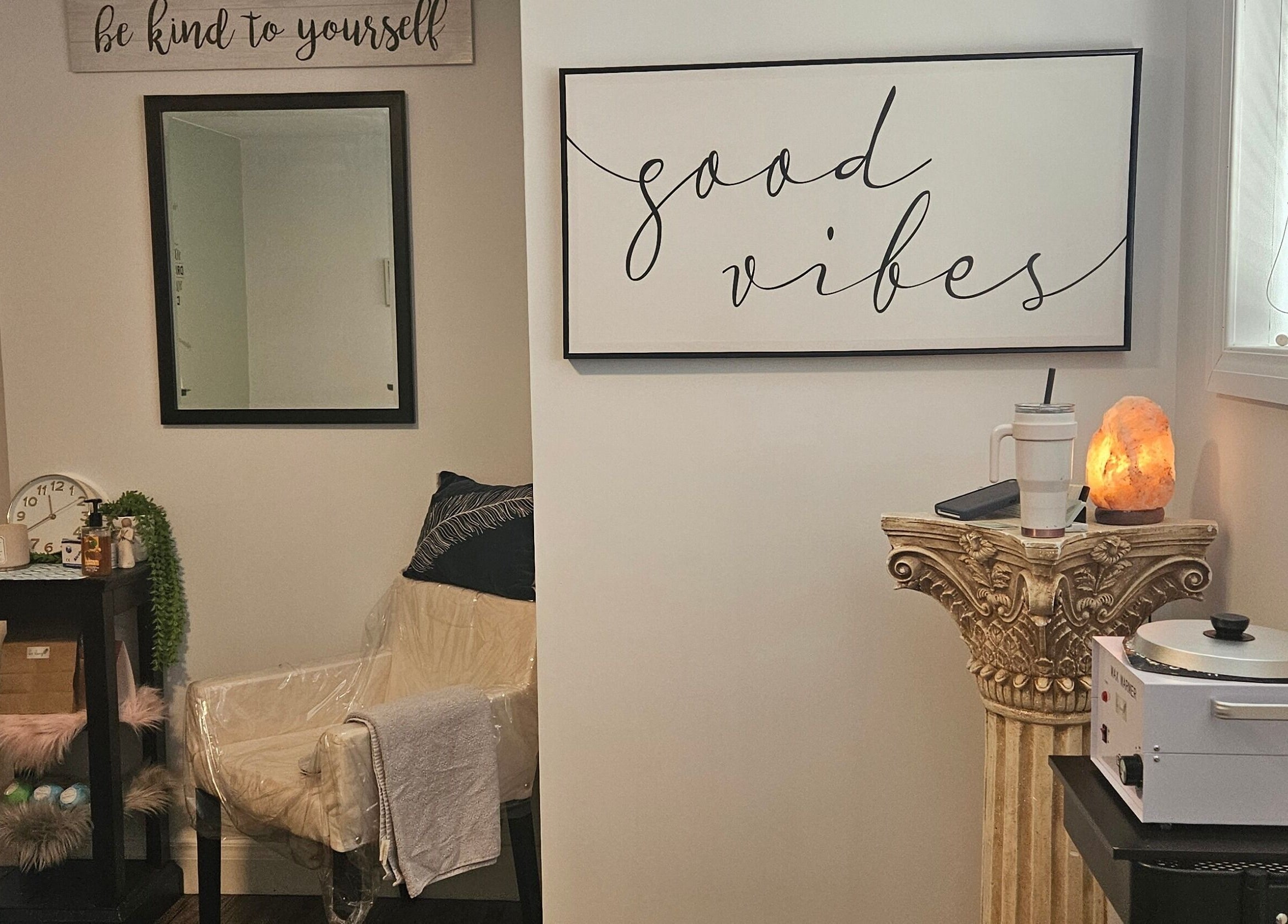 Cozy room at Pure Waxing, Quinte West, Ontario, CA with 'good vibes' art and Himalayan salt lamp.