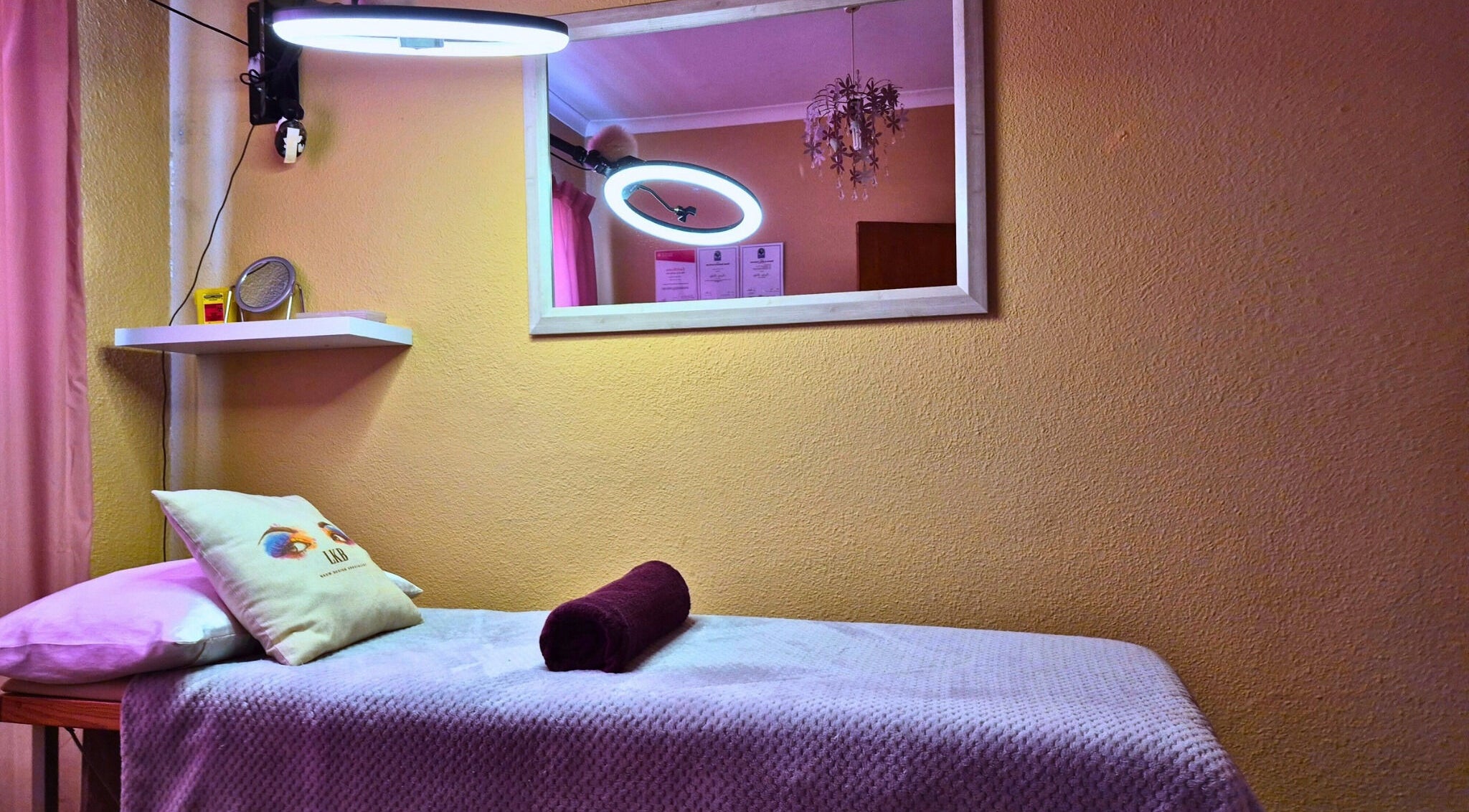 Relaxing spa treatment room at Leigh Kays Beauty, Cape Town, Western Cape, ZA, with soft lighting and cozy decor.
