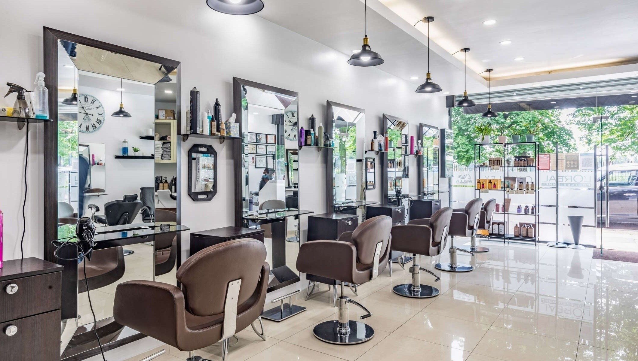 Modern interior of La Coupe salon in London, England, GB with stylish mirrors and chairs.