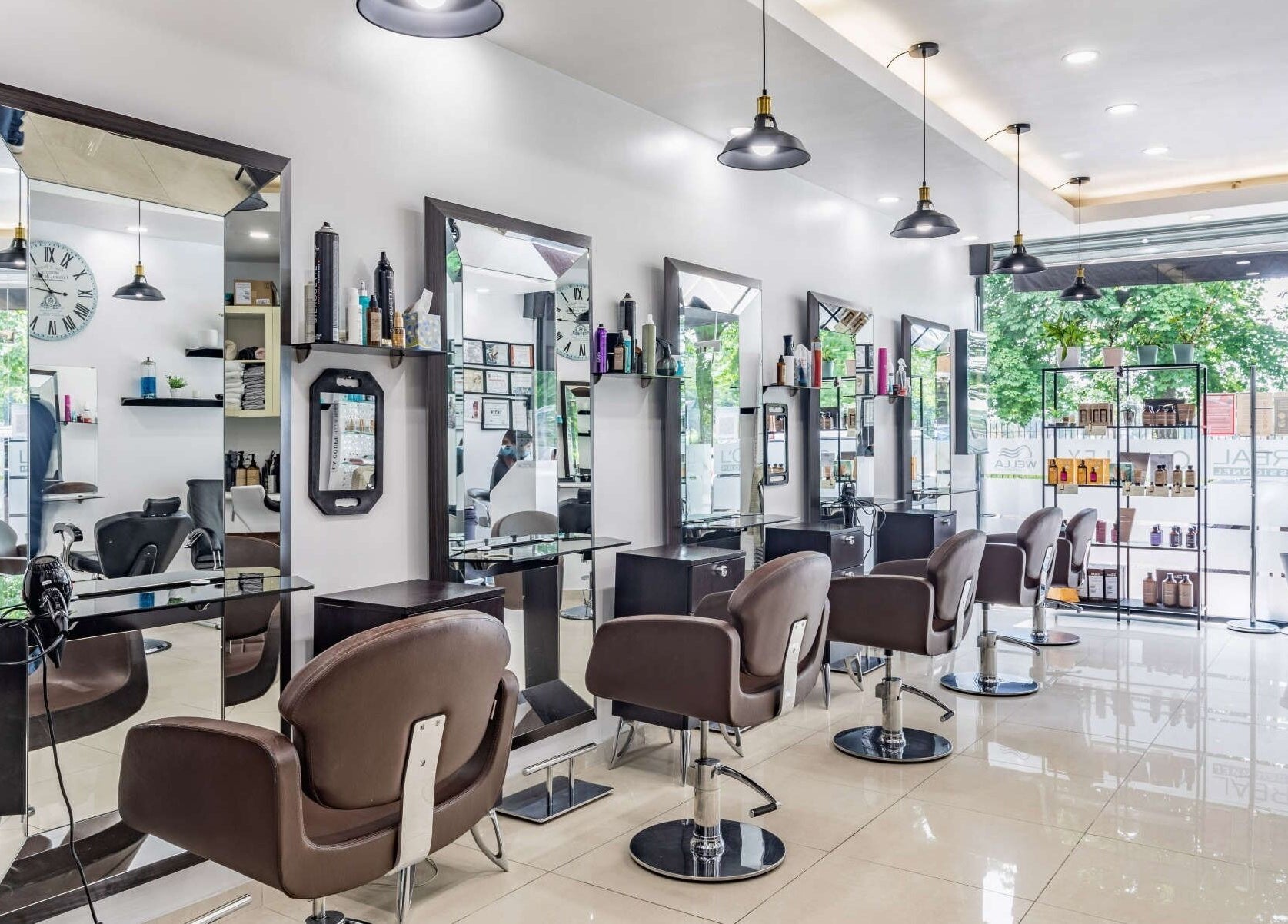 Modern interior of La Coupe salon in London, England, GB with stylish mirrors and chairs.