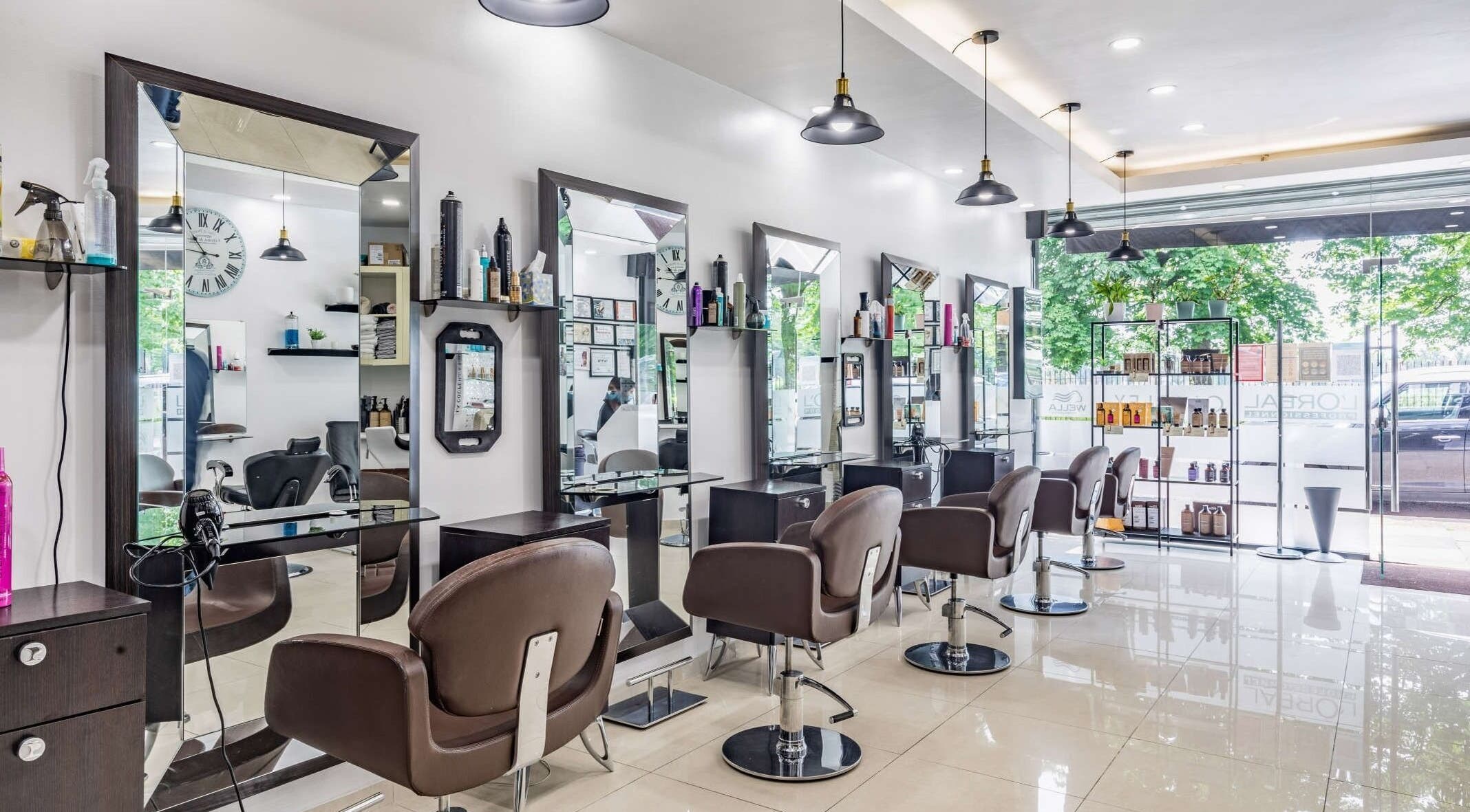 Modern interior of La Coupe salon in London, England, GB with stylish mirrors and chairs.
