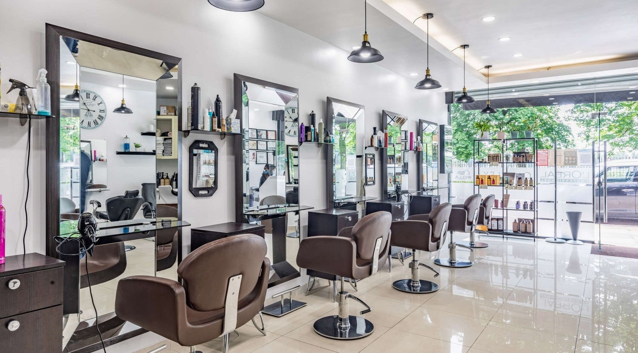 Modern interior of La Coupe salon in London, England, GB with stylish mirrors and chairs.