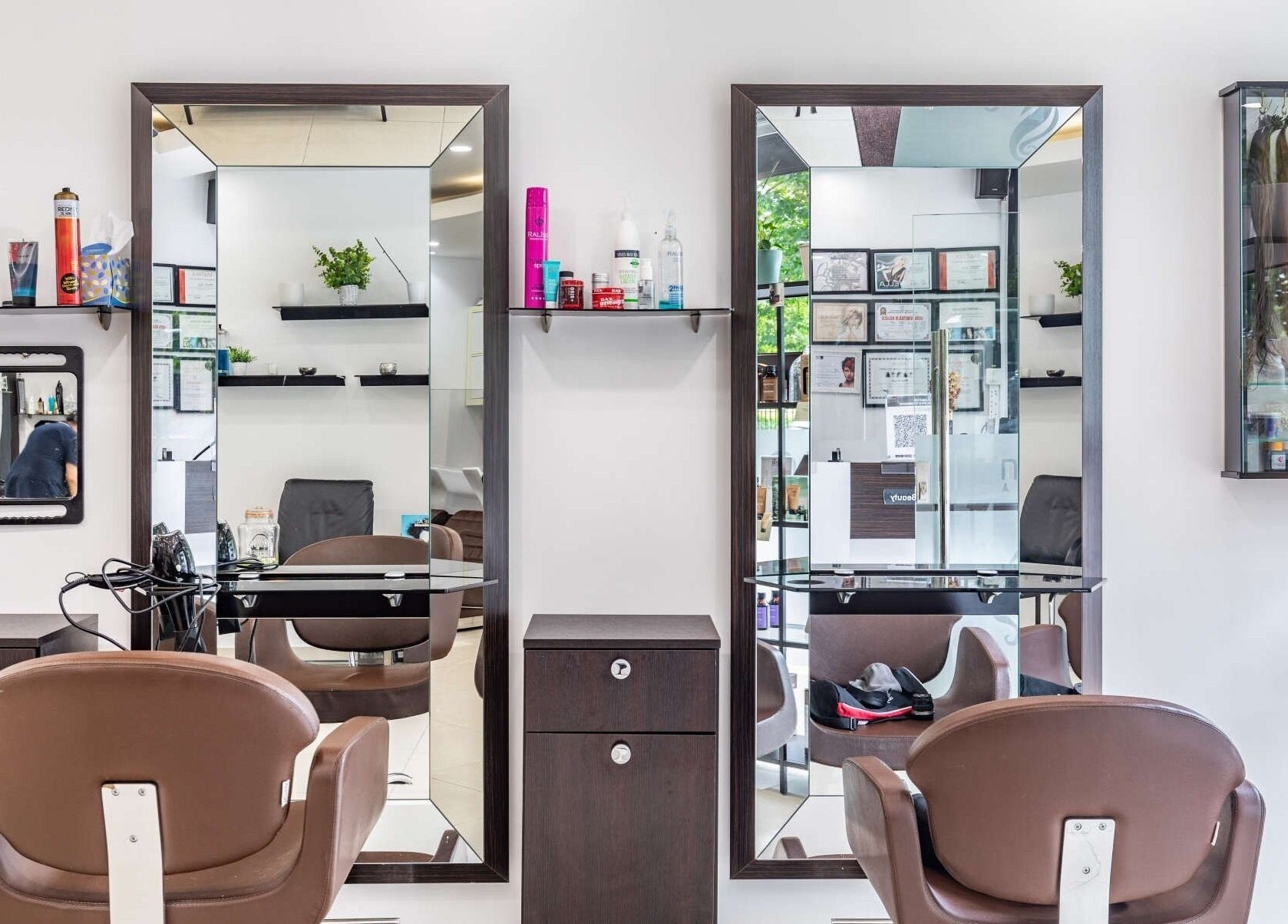 Modern salon interior at La Coupe, London, England, GB, featuring chic styling stations and mirrors.