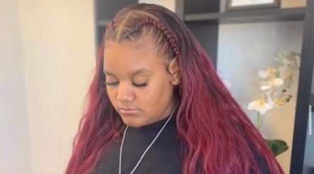 Stylish red braided hair at The Root Refresh Salon in Minneapolis, Minnesota, US.