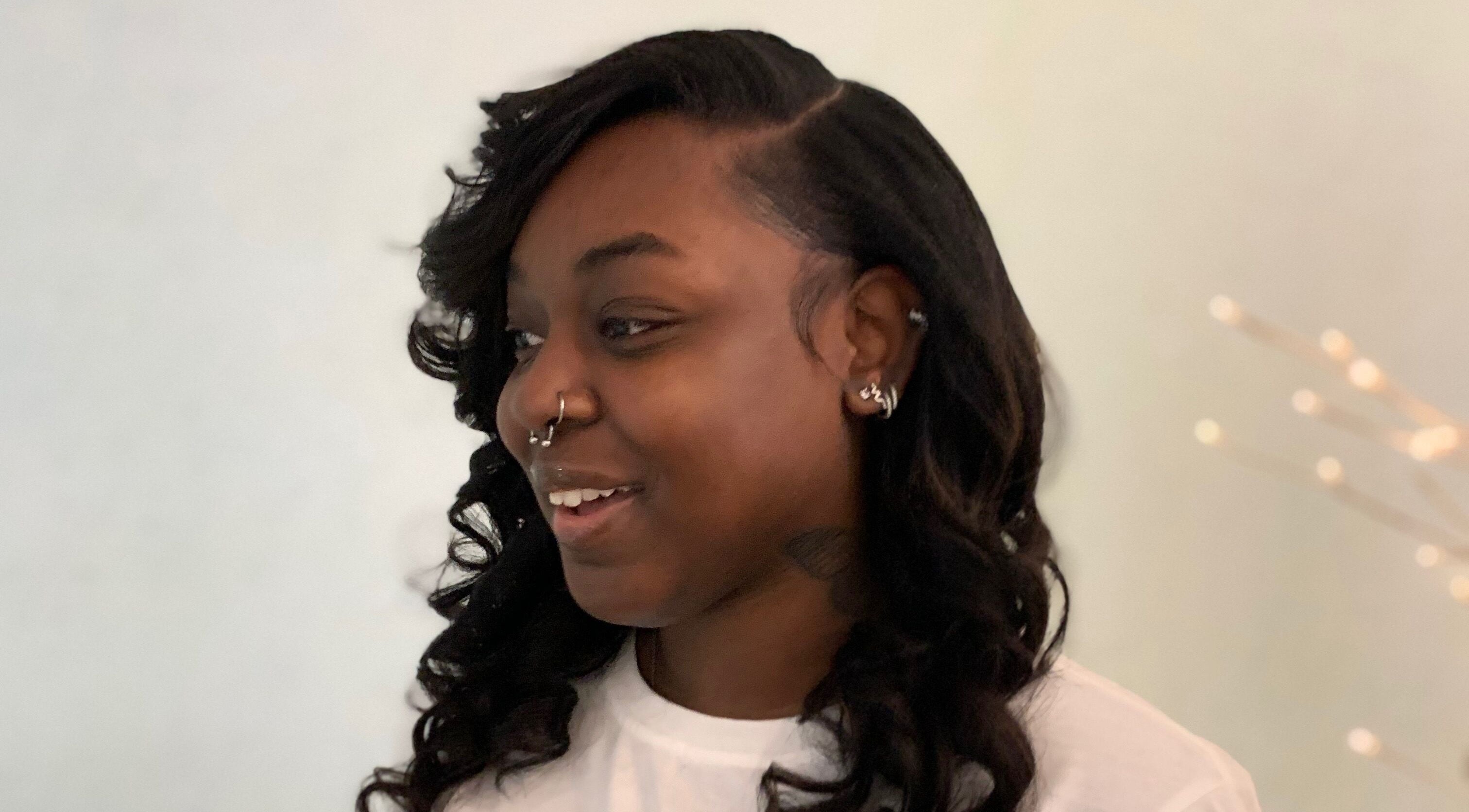Customer smiling with styled hair at The Root Refresh Salon, Minneapolis, Minnesota, US.