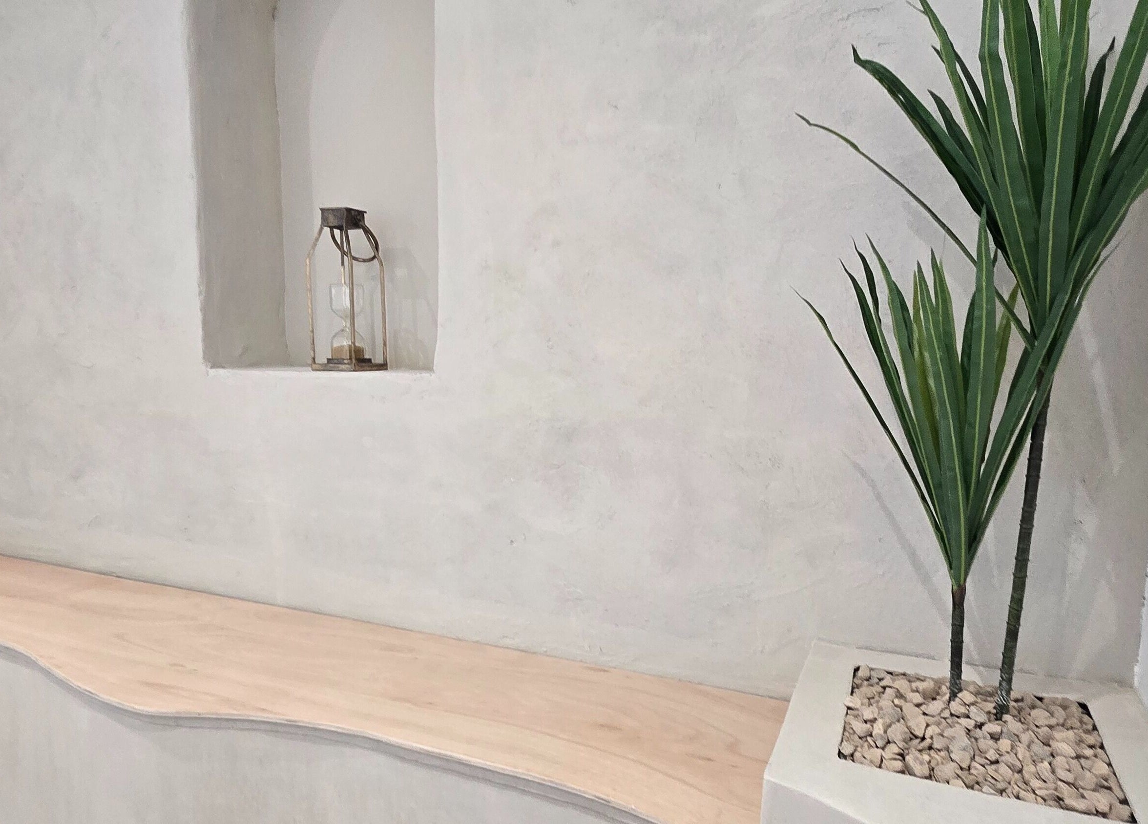 Minimalistic decor at U Aesthetics in South Elmsall, England, GB, featuring a plant and hourglass.