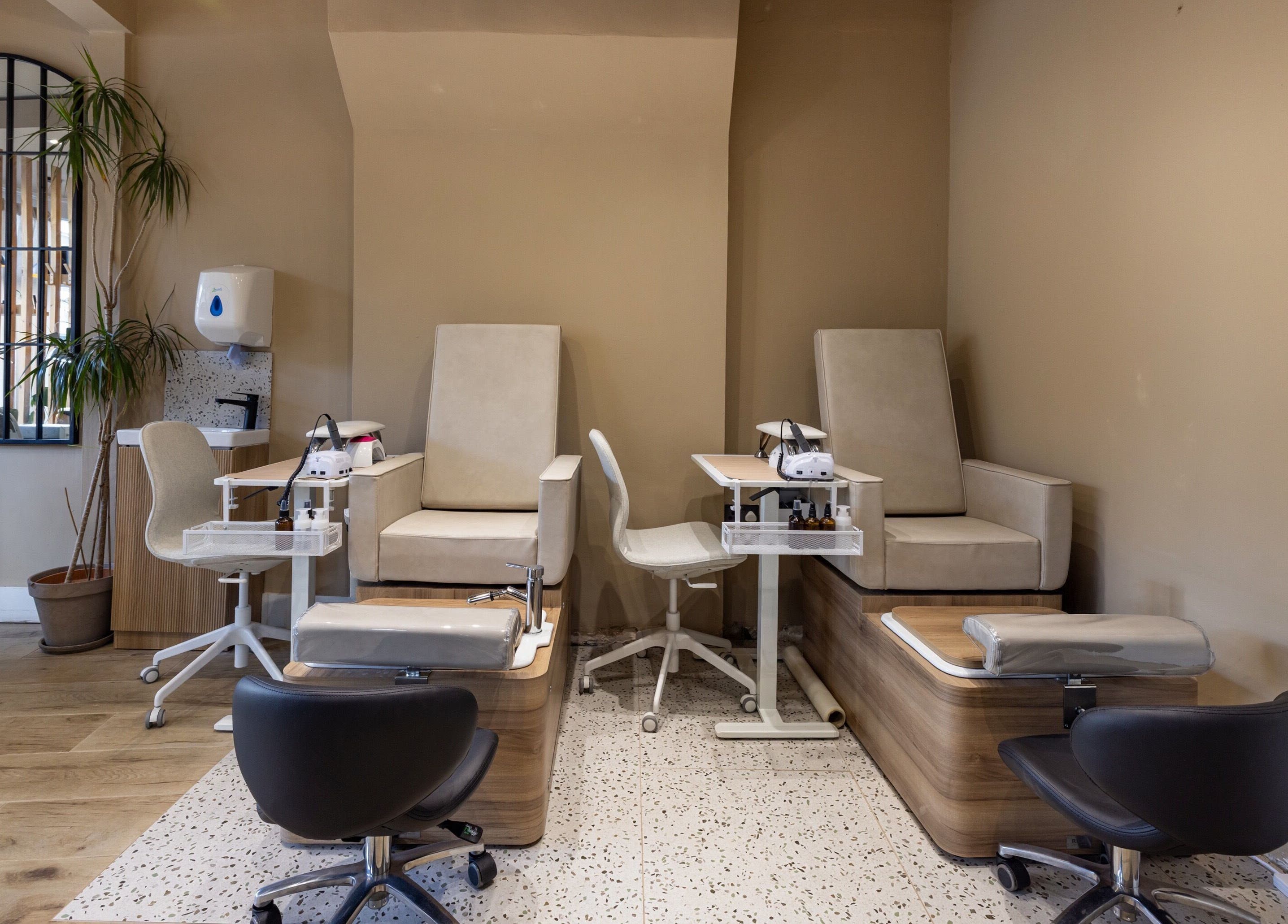 Chic nail spa at Skip The Filter Fulham Beauty, London, England, GB with sleek chairs and modern decor.