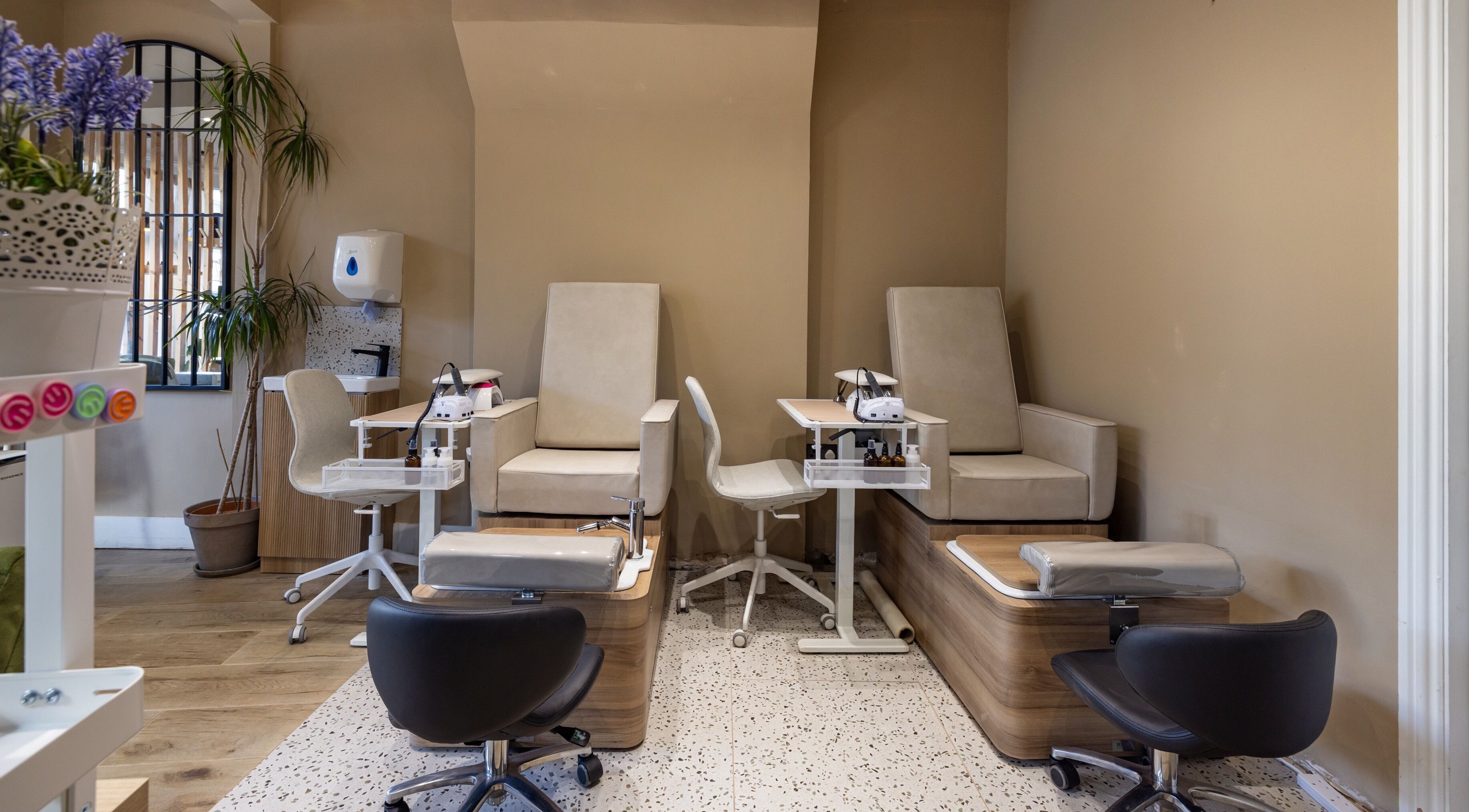 Chic nail spa at Skip The Filter Fulham Beauty, London, England, GB with sleek chairs and modern decor.