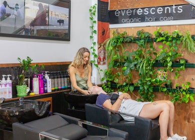 Stylist at Chameleon New Age Salon 🌈 in Surfers Paradise, Queensland, AU, providing a relaxing hair wash.
