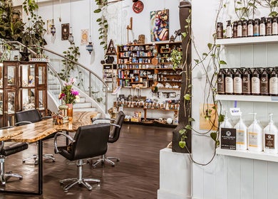Interior of Chameleon New Age Salon in Surfers Paradise, Queensland, AU, showcasing elegant decor and styling products.