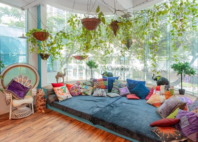 Chameleon New Age Salon's vibrant bohemian lounge with colorful pillows in Surfers Paradise, Queensland, AU.