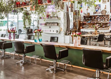 Interior of Chameleon New Age Salon, Surfers Paradise, Queensland, AU, featuring stylish chairs and greenery.