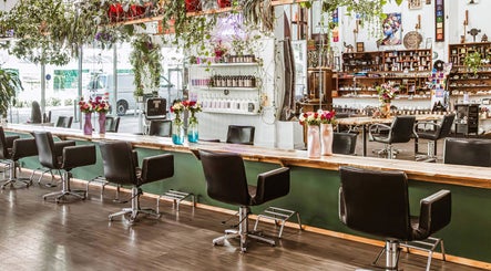 Interior of Chameleon New Age Salon, Surfers Paradise, Queensland, AU, featuring stylish chairs and greenery.