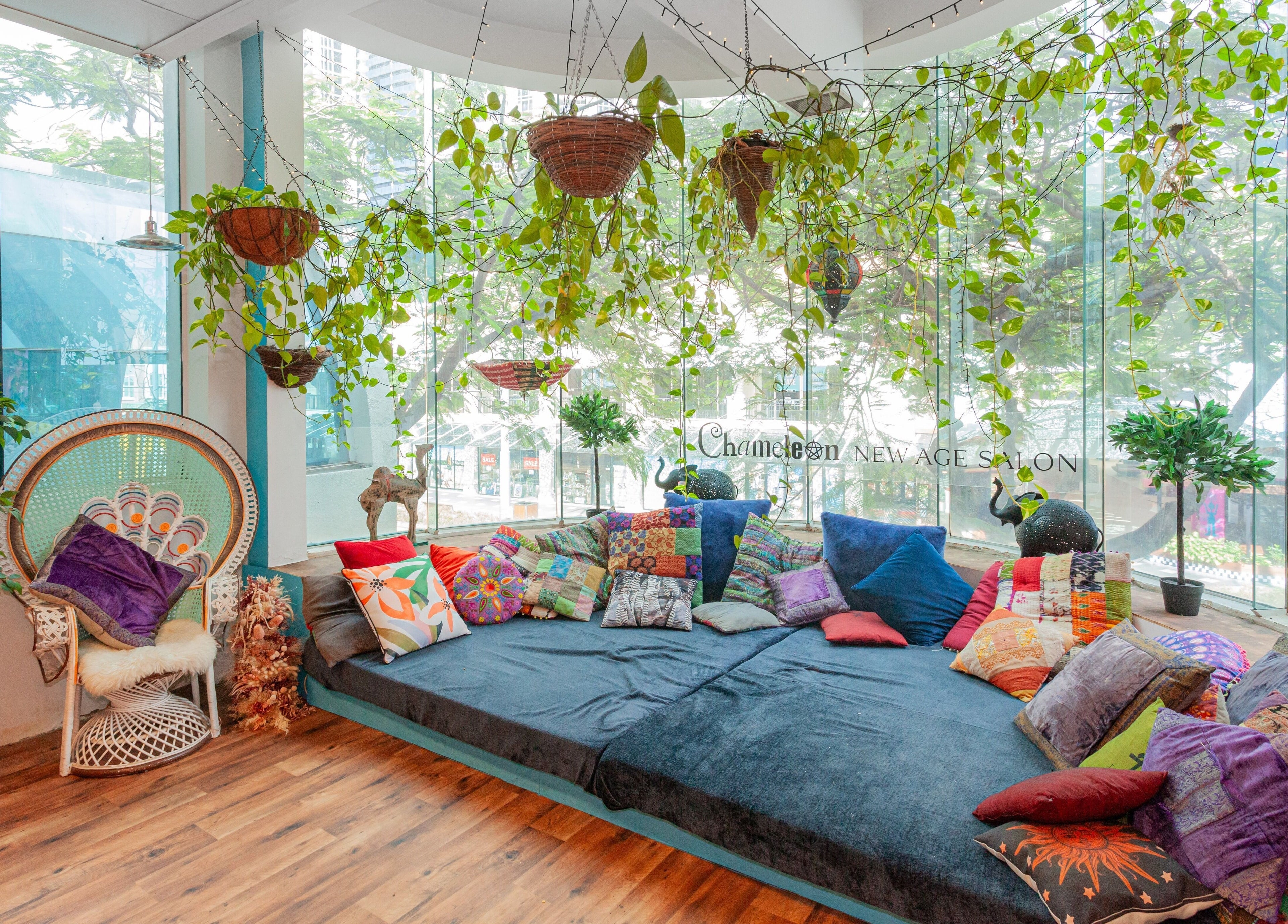 Cozy boho lounge with vibrant cushions at Chameleon New Age Salon, Surfers Paradise, Queensland, AU.